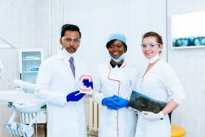 Medical Professionals with Teeth Model and X-ray